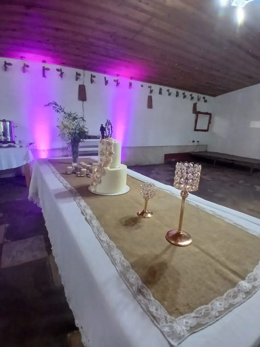 Mesa principal decorada con mantel blanco y candelabros